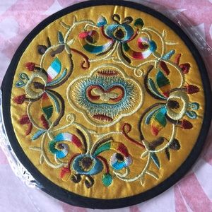 A pair of embroidered coasters